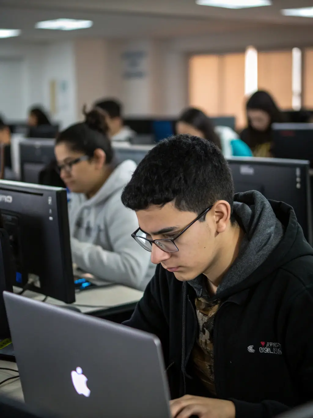 A-Level students working on a Computer Science project in a modern ICT lab at Chinhoyi High School. The students are collaborating and using advanced software and hardware.